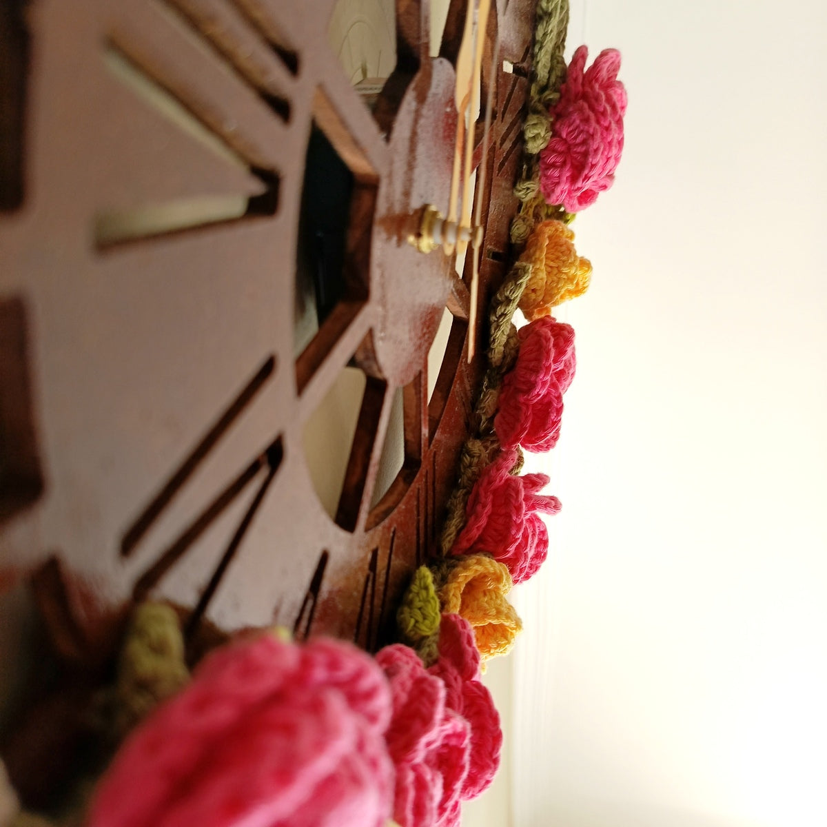 Decorative wall clock with colorful floral elements on a white background