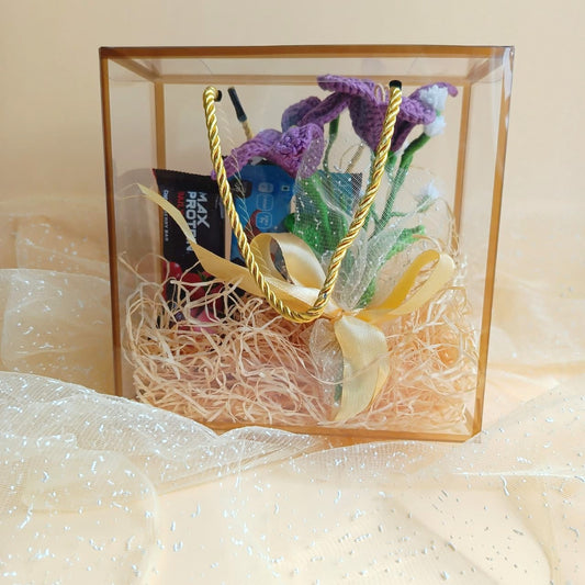 Decorative gift box with crochet flowers bouquet and protein bars