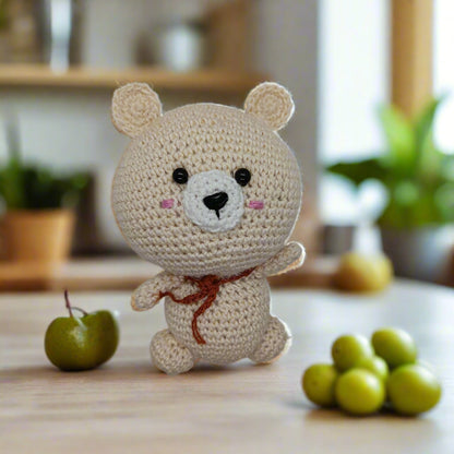 Crocheted bear toy with a brown muffler for kids