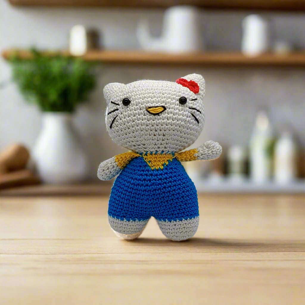 Crocheted cat toy with a red bow for kids
