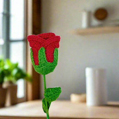Crocheted red rose with green leaves for gift and decor
